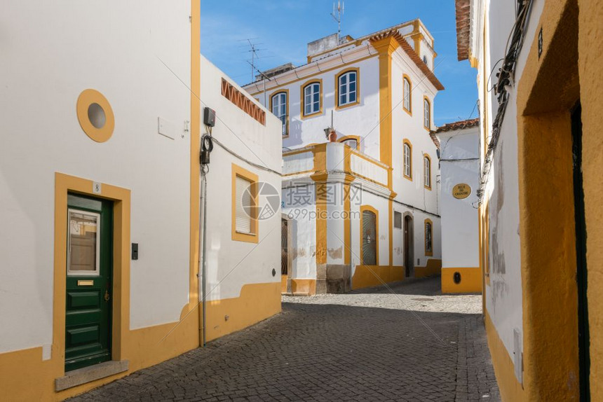 Evora狭小的街道与黄白色房屋景象图片