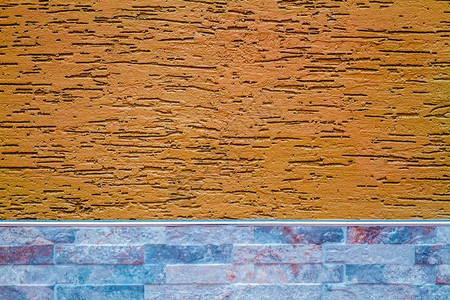 涂有装饰石膏的橙色墙作为质地和背景图片