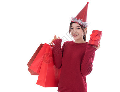 带着圣诞礼物盒和购袋的快乐女人孤立在白色背景上图片