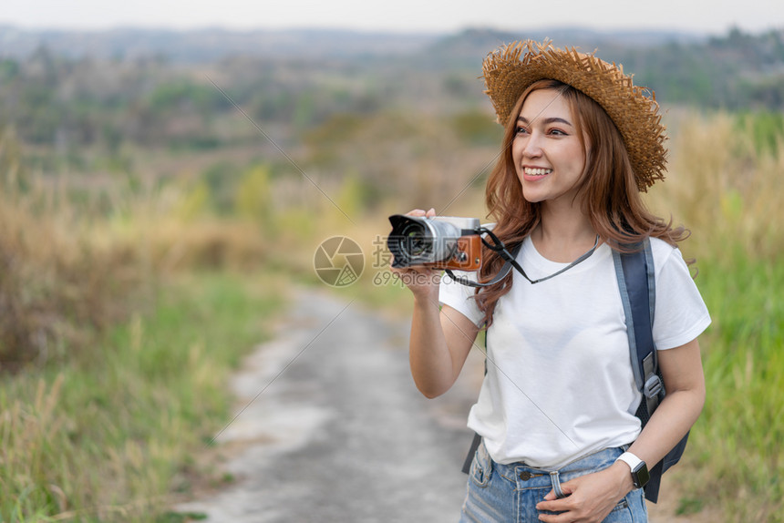 旅游女客用摄像头拍照片图片