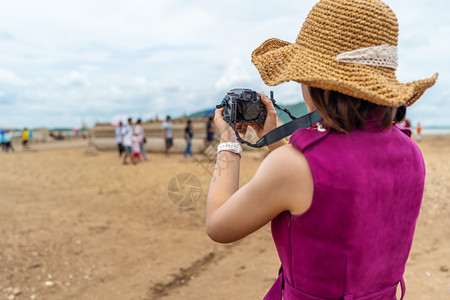 旅行妇女在农村拍摄带有相机的片图片