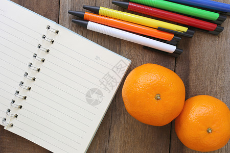 用于设计背景的关旧木笔记本和圆橘子用于记录或添加文字的空白纸图片
