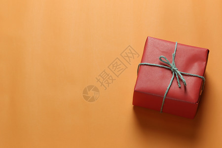 红圣诞礼物盒放在橙色艺术纸地板上复制您作品的设计空间重要一天的概念图片