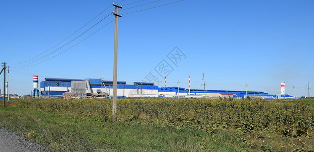 大型废金属加工厂大型旧金属提炼工大楼的蓝色屋顶排气管散热器冷却工业单位以及办公楼背景图片