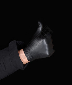 男主厨用黑色乳胶手套和制服握的男主厨表现出一种赞同的姿态例如图片