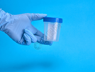蓝色背景带有空塑料罐子的手套用于体检图片