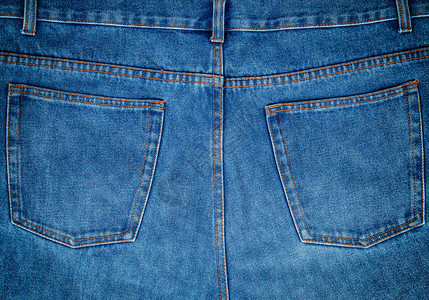 蓝色牛仔裤的碎片背口袋整身背景图片