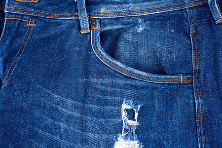 蓝色牛仔裤织布的碎片一个洞完整的框架关闭图片