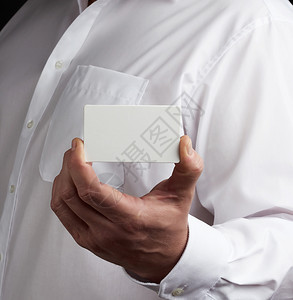 男手持长方形空白纸名片男子身着白衬衫是商人的模板图片