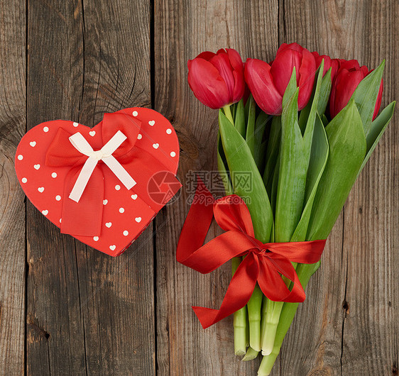 红色盛开的郁金香花束配有绿色叶子灰木形背景的包装礼物生日情人节周年纪念日的节背景图片