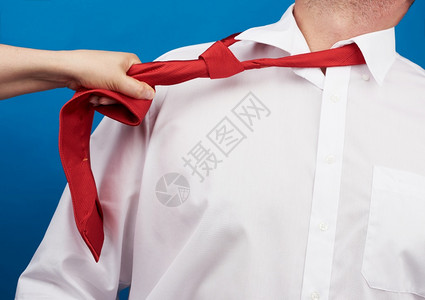 一名身着白衬衫工作场所暴力概念骚扰和支配的成年男子脖上绑着红色丝绸带图片