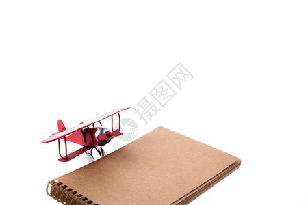 白色背景的飞机和笔记本图片