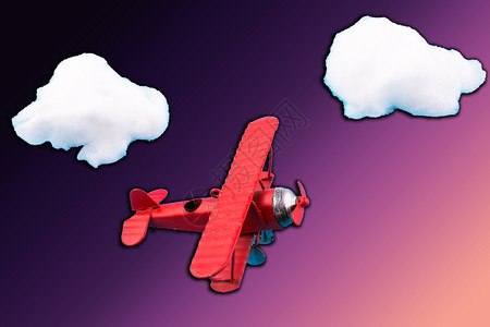 天空中的背景图有一架红色模型飞机图片