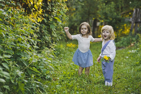 孩子们沿着夏令营走一个男孩和女走在绿色花园4760图片