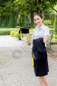 毕业帽子手握着快乐的毕业女学生图片