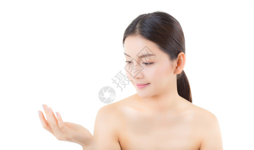 亚洲美丽的年轻女展示健康干净的皮肤展示手掌上空的隙与白色背景美貌概念隔绝图片
