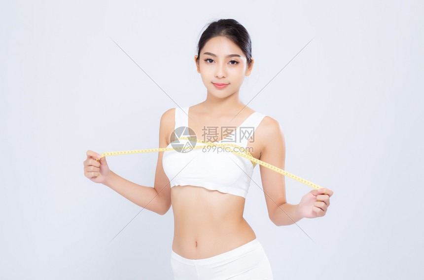 美丽的肖像女一样饮食与测量乳房和增殖的苗条相隔绝在白色背景上女孩会因胶带测量健康和概念而丧失纤维素图片