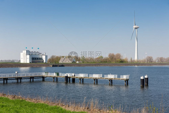 荷兰湖IJsselmeer靠近Medemblik带滑水风涡轮机和码头图片