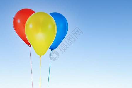 三个红色黄的蓝气球用于生日和在蓝天空孤立的庆祝活动并复制免费文字空间图片