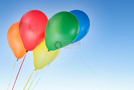 用于生日和庆祝活动的多彩气球在蓝天与世隔绝并有免费文本的复制空间用于生日和庆祝活动的多彩气球图片