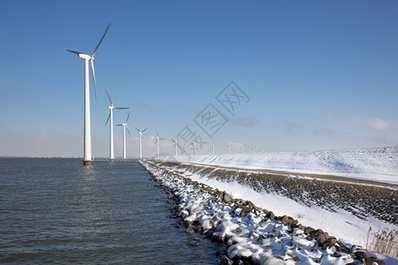 冬季沿杜奇海岸的长排离风涡轮松雪冬季沿杜奇海岸的离风涡轮松雪冬季沿杜奇海岸的离风涡轮松和雪图片