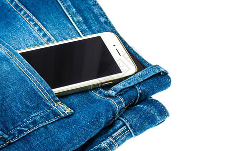 蓝色牛仔裤口袋中的移动电话图片