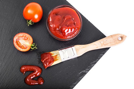配有番茄酱和黑石本面刷子的碗番茄和黑石本面刷子的碗工作室照片图片