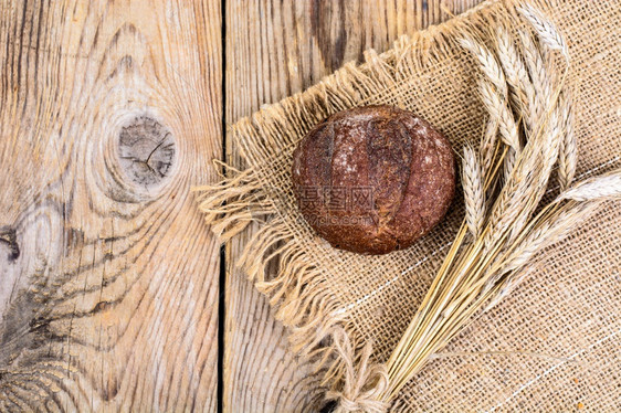 谷物和面包在旧木制桌上的谷物和面包工作室照片谷物和面包在旧木制桌上的谷物和面包图片