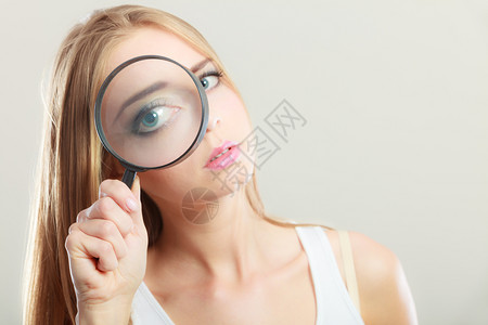调查探究教育理念特写女人的脸女孩拿着放大镜放大图片