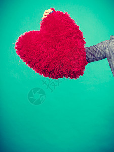爱浪漫情人节的礼物想法概念女人抱着大红毛发枕头的心脏形状女人抱着红枕头的心脏形状图片