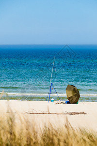 渔具和帐篷单独留在海滨岸边阳光的夏季天气渔具和海边的帐篷图片
