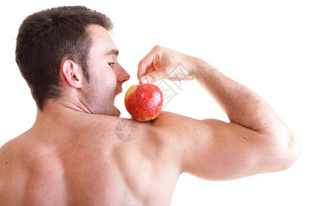 红苹果在人类比塞普肌肉上被白色隔绝图片