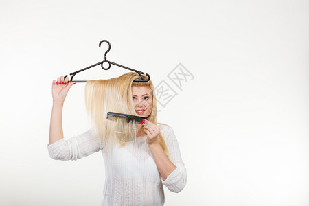 美发型和销售概念金发女人在衣架上抓头发金女人在衣架上抓头发图片