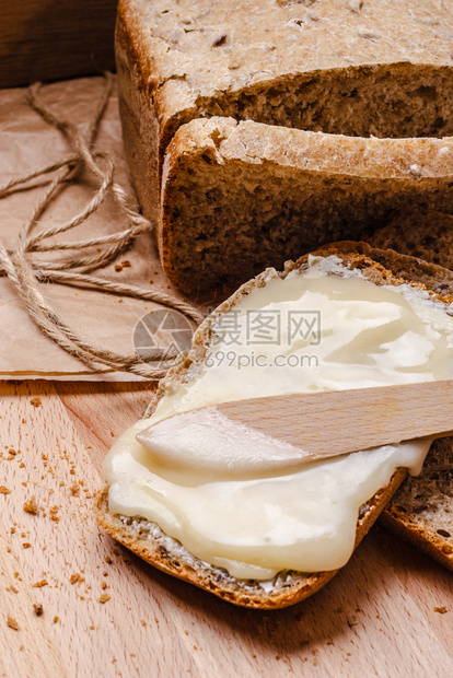 鲜活生命整个小麦面包黄油和蜂蜜生木桌背景图片