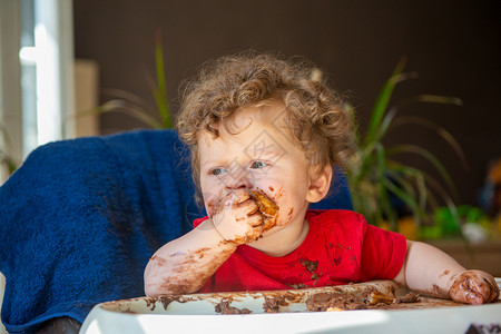婴儿正在吃巧克力蛋糕图片