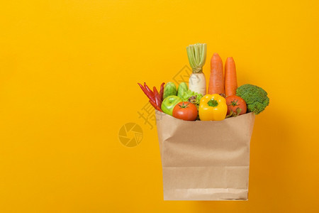 黄背景的杂货袋蔬菜图片
