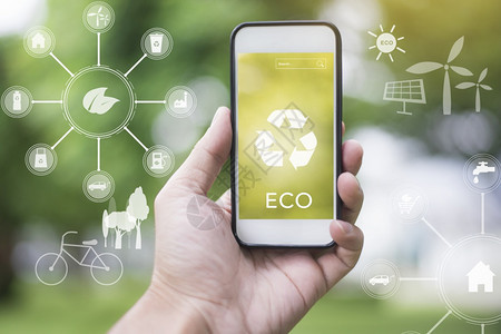 使用智能手机在绿色和生态图标的绿色上使用智能手机来贴近人拯救地球概念图片