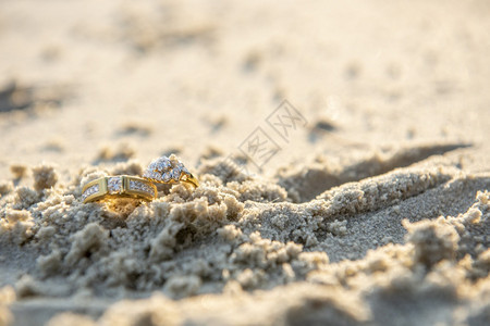 一对在海滩上的结婚戒指图片