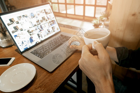 在咖啡店用电脑工作的关紧的年轻人图片