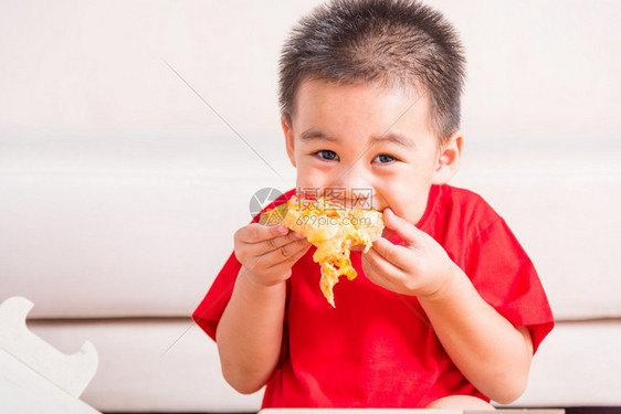 热自制蔬菜快意大利食品可爱的小孩享受吃着送披萨辣椒尼奶酪很多美味的切片在家里一个开着的纸箱里图片