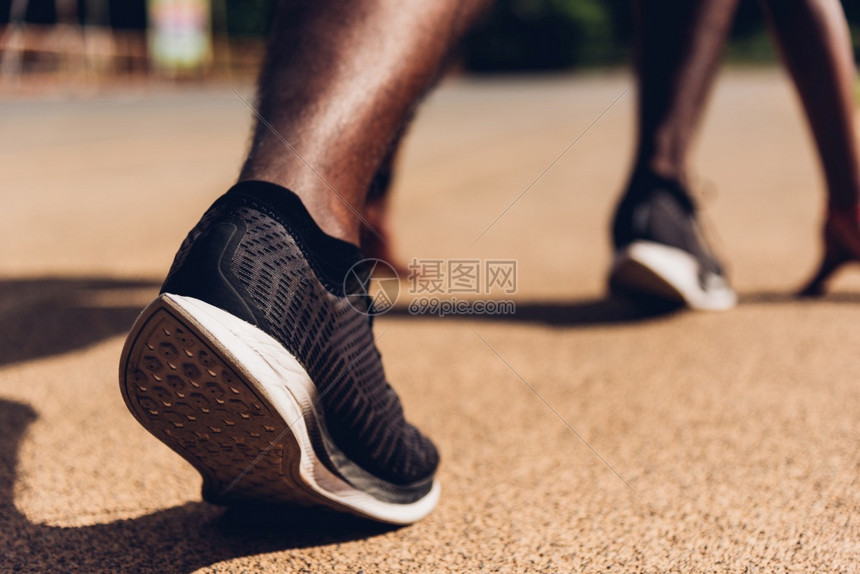 亚洲青年运动员跑亚洲黑人者积极准备在户外运动场上开始训练以便向前迈出一步健康锻炼在脚鞋上闭合图片