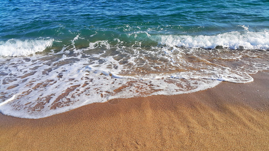 海浪沿沙砂中含有白泡沫的海浪天然封闭背景图片
