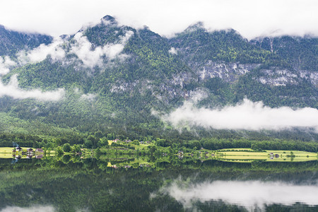 奥地利Hallstattersee的雨和云清晨的雾笼罩在奥地利的风景上有湖森林田地牧场草原和村庄图片