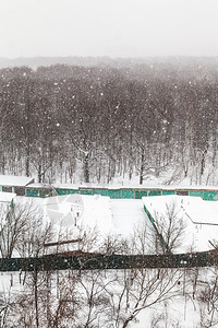 在莫斯科市Timiryazevskiy公园的树林和车库下雪图片
