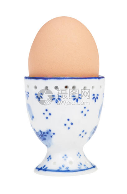 陶瓷鸡蛋杯中棕色煮的侧面视图带有尖点最终在白色背景上被孤立图片