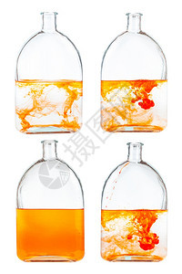 玻璃瓶中的橙色墨水溶液套装在玻璃瓶中与白色背景隔绝图片