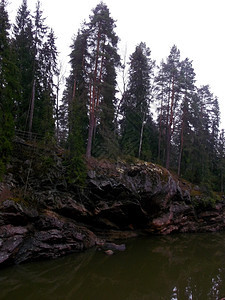 银行溪在灰色天空背景下河岸高岩层边的石堤岸多的图片