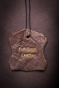 产品缝时尚皮带标签有全谷类皮带文字塞在金子中图片