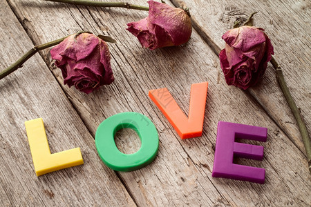 情怀美丽的婚姻带字词干玫瑰木背景上的爱图片