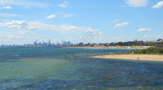 与墨尔本市天际线搭配的布赖顿海滩浴池澳大利亚城市的冲浪图片